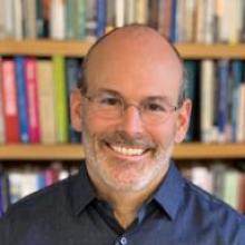 photograph of Judson Brewer with bookshelves in the background.